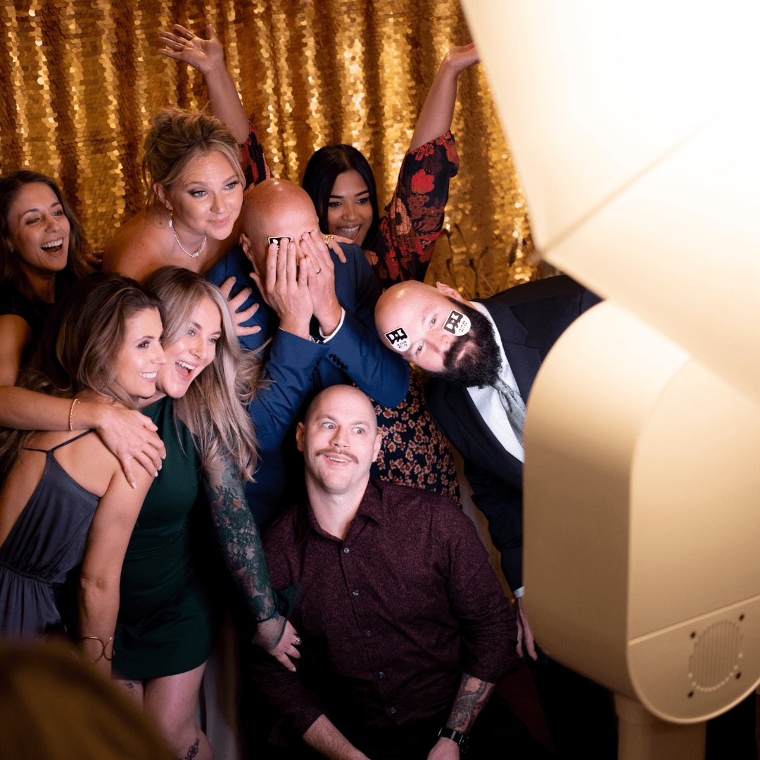 Couple posing in front of photo booth